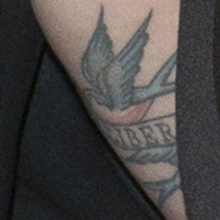 The Sparrow tattoo on Potente's upper left arm is not easily visible but it exists